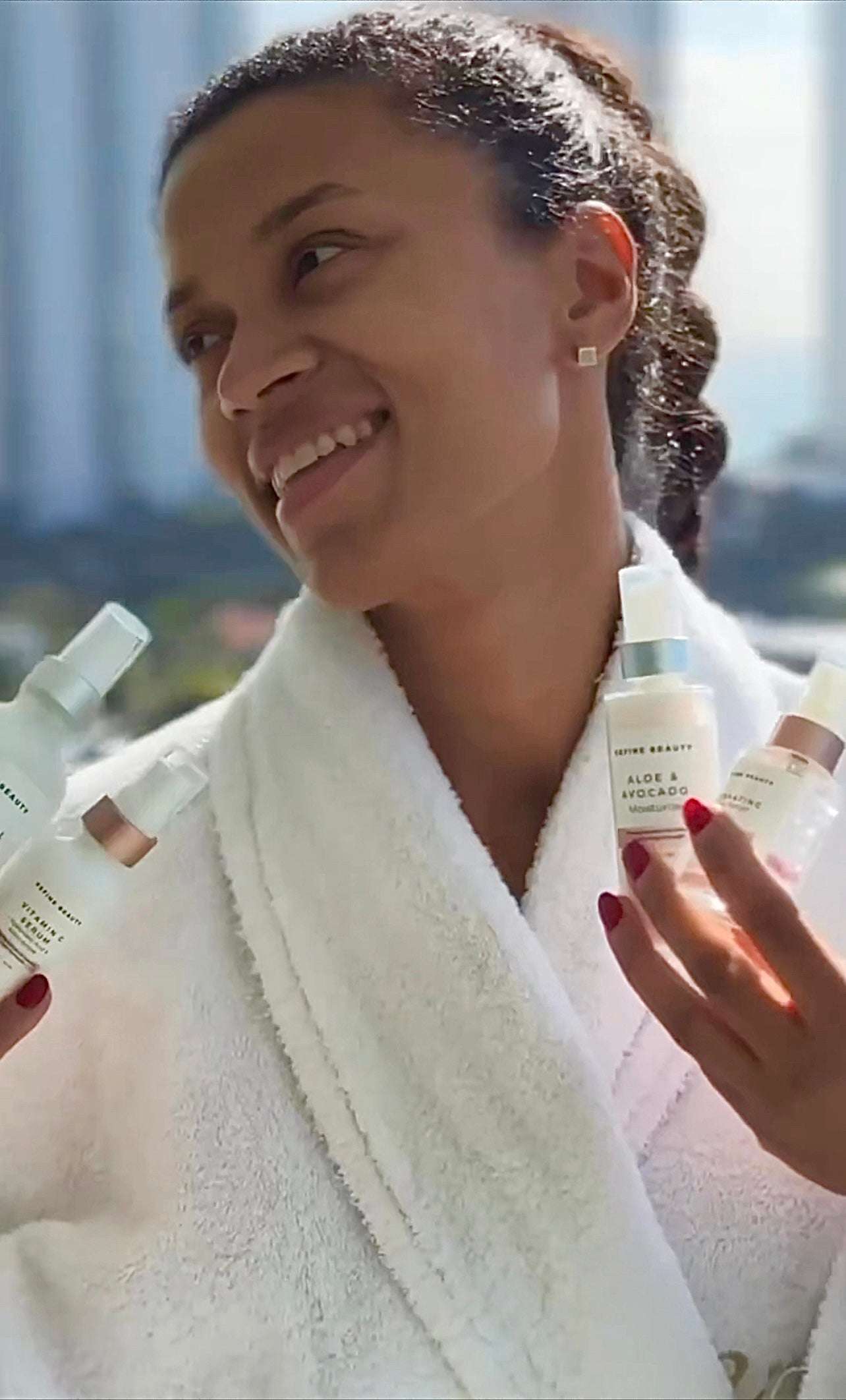 African American model applying the REFINE BEAUTY Limited Edition Hydration Glow Skincare Set