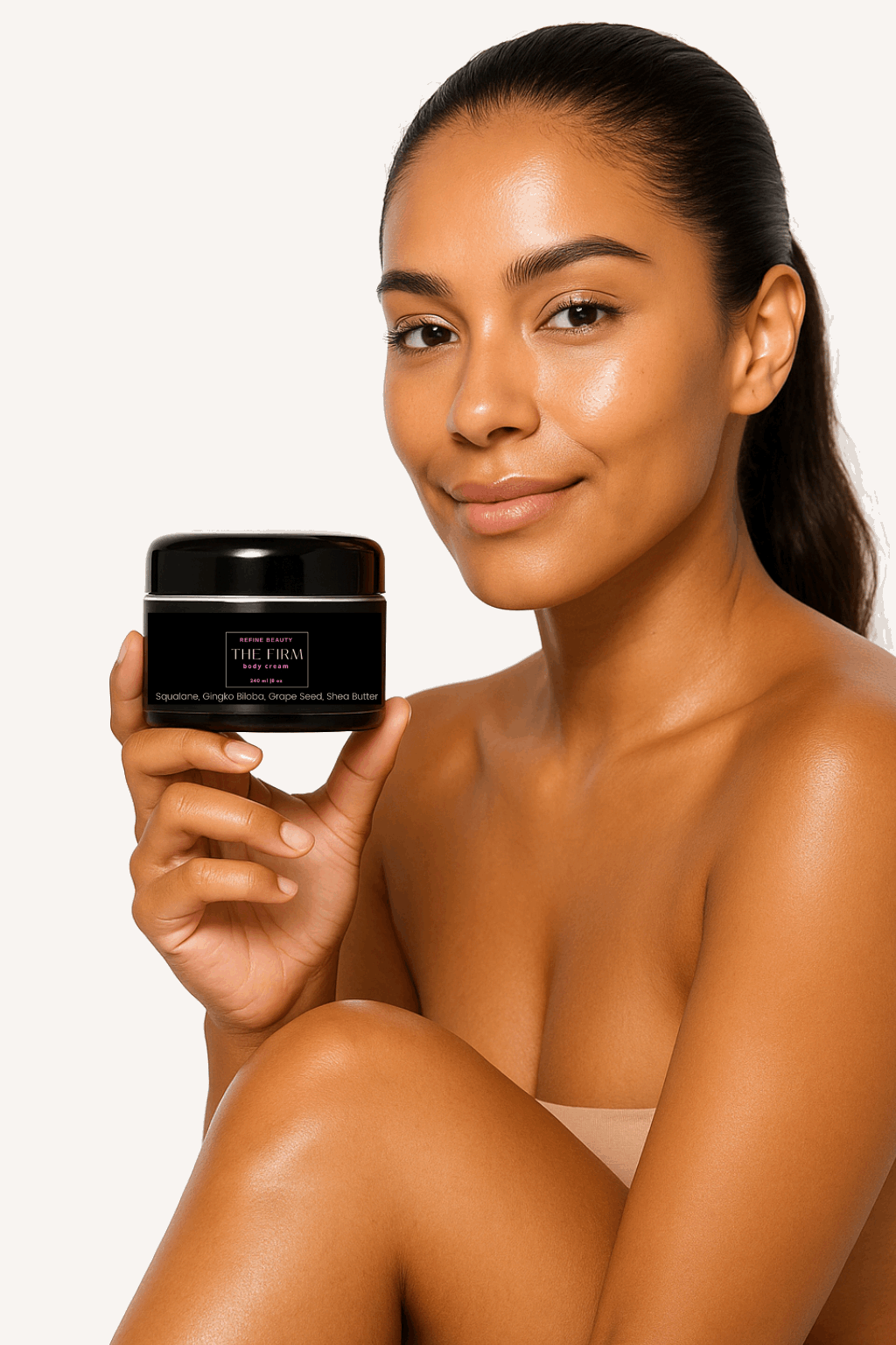 Brown skin Model with tight ponytail
holding Refine Beauty The FIRM Body Cream