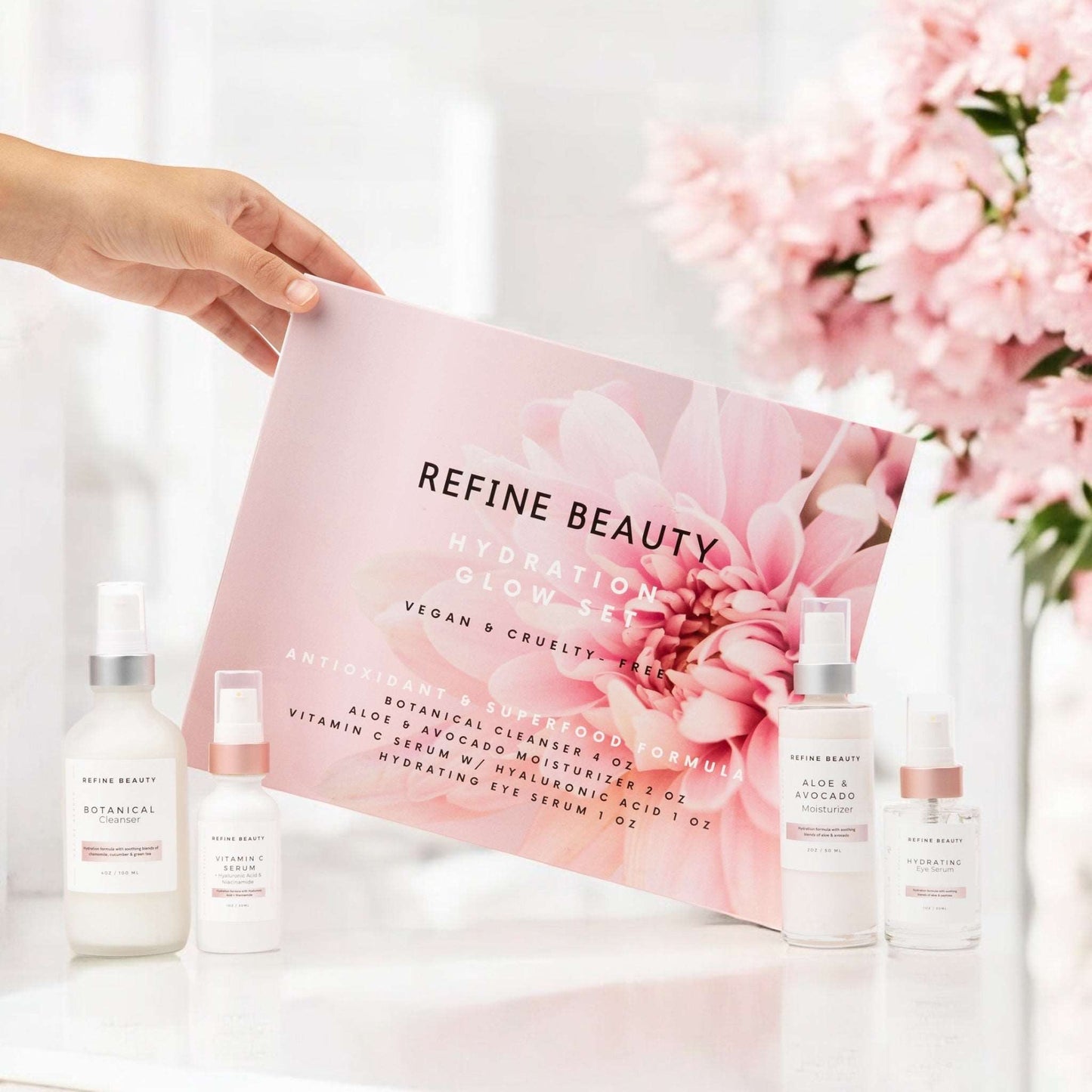 Model holding Refine Beauty Hydration Glow set