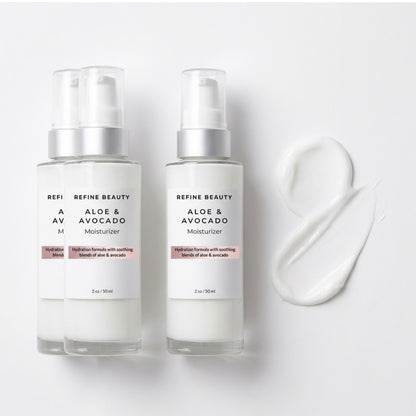 Two bottles of Aloe & Avocado Moisturizer by Refine Beauty on a white background with a smear of the product.