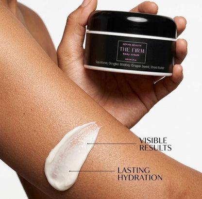 A hand holds a black jar of  Refine Beauty The Firm body cream over a person's forearm with a smear of the white cream shown beside text reading VISIBLE RESULTS and 'lLASTING HYDRATION