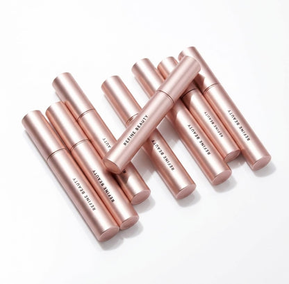 Refine Beauty Volume mascaras tubes on white background 