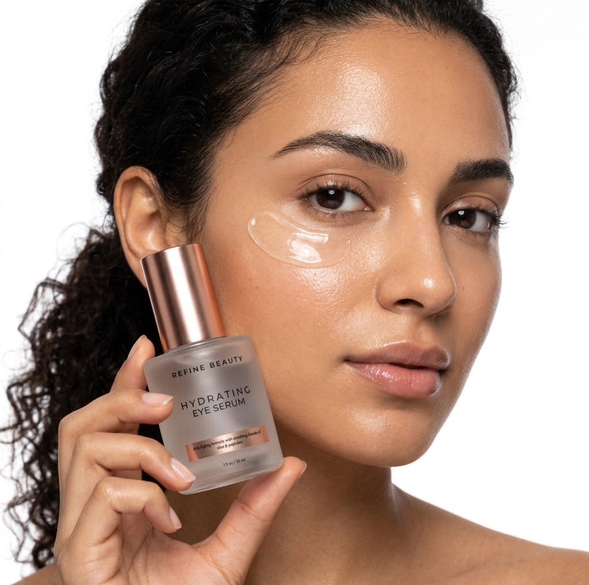 Model holding Refine Beauty Hydrating Eye Serum with clear gel swatch on white background 