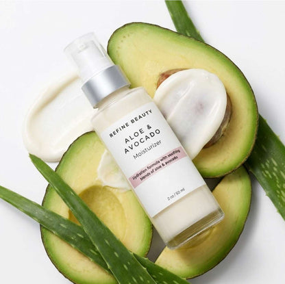 Refine Beauty Aloe & Avocado Moisturizer surrounded by avocados and aloe vera leaves on a white background