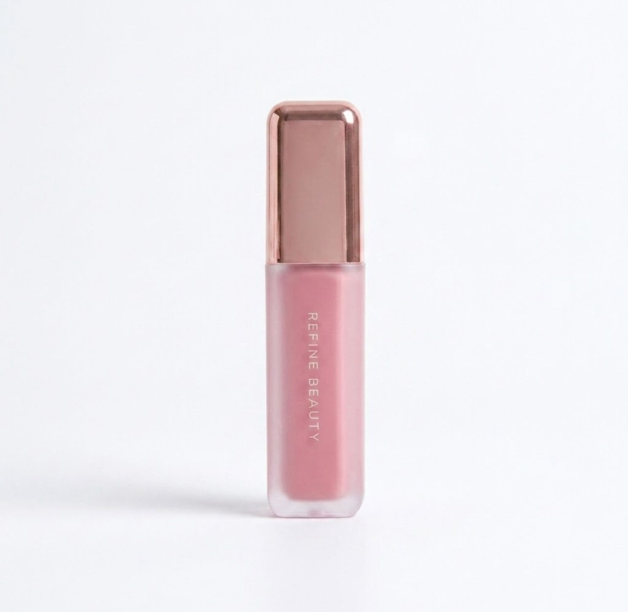 Refine Beauty blush with rose gold cap on a white background with rose gold cap on a white background