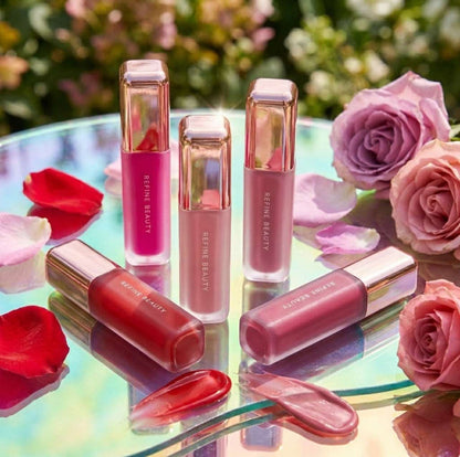 Refine Beauty blush with rose gold accents on a reflective surface with flowers in the background