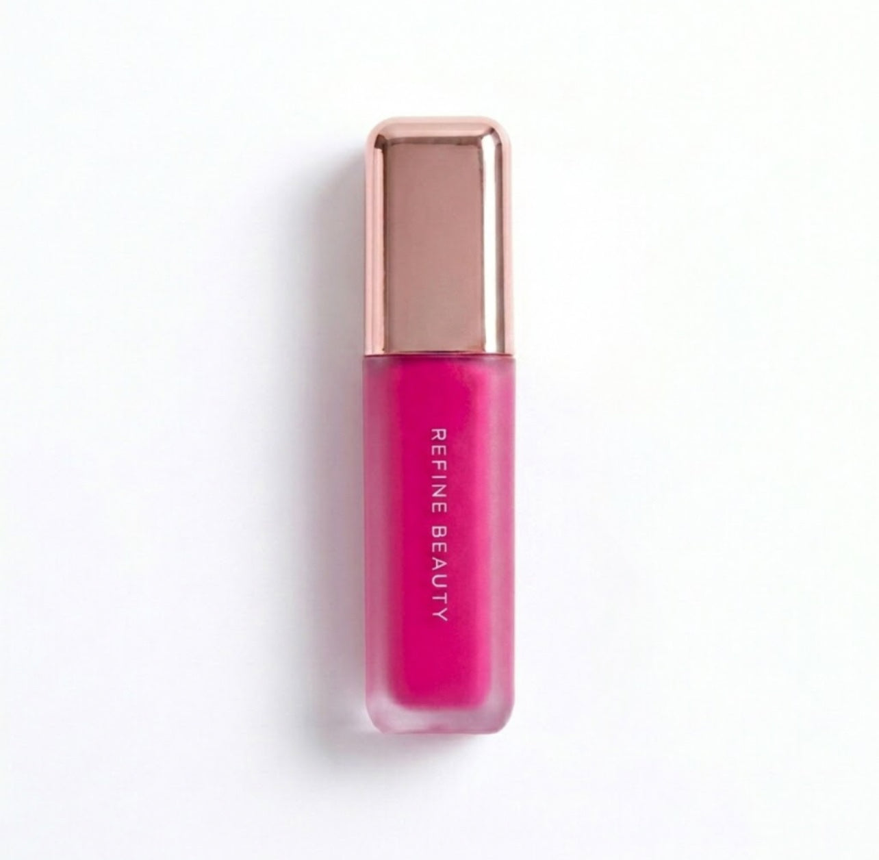 Refine Beauty blush with rose gold cap on a white background 