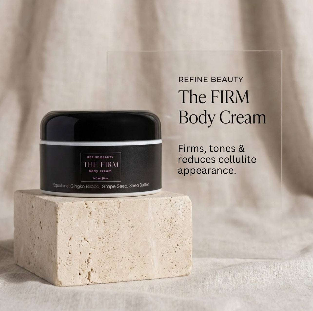 Black jar of Refine Beauty The Firm body cream on a beige stone block with text about its benefits.