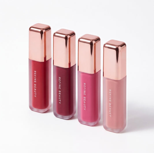 Four Refine Beauty liquid blush bottles with rose gold caps on a white background