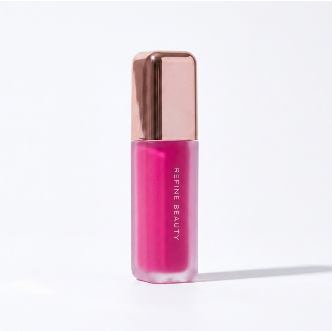 Refine Beauty blush with rose gold cap on a white background