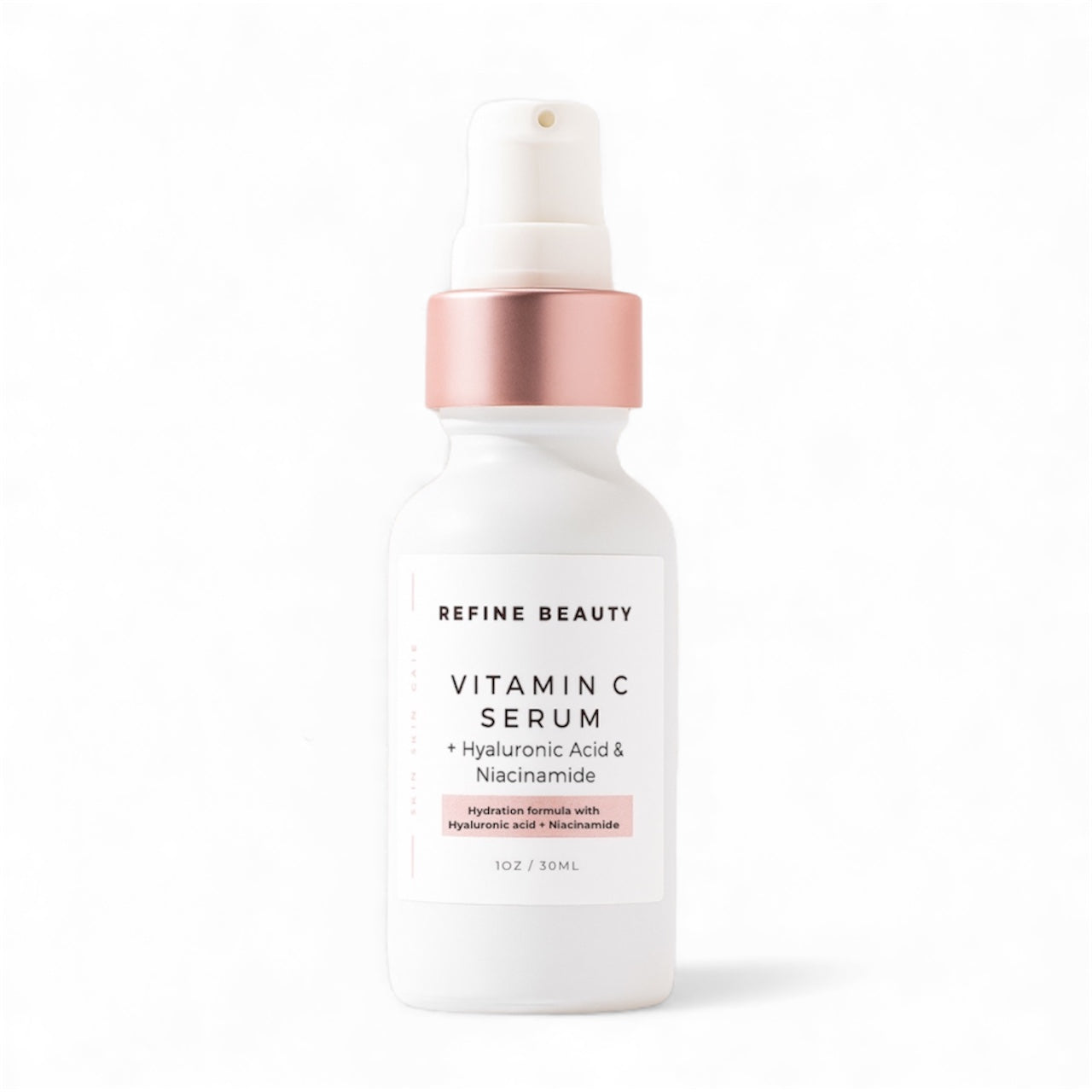 Refine Beauty Vitamin C serum bottle with rose gold cap on a white background