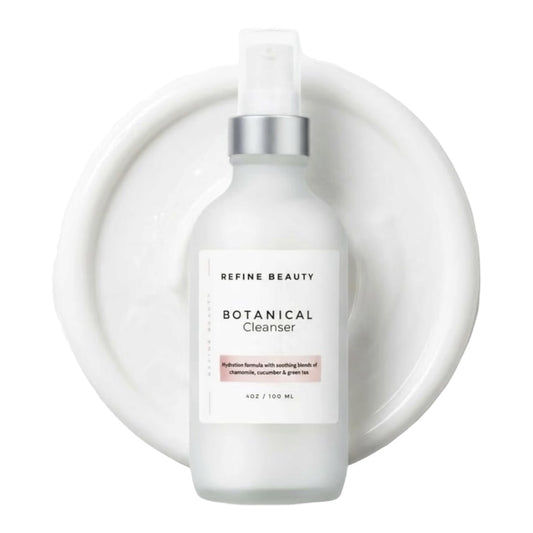 A frosted white bottle of Refine Beauty Botanical Cleanser with a silver pump and clear cap, set against a white circular background.