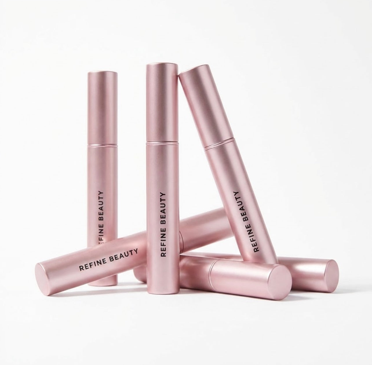 Set of Refine Beauty Volume mascara products on a white background