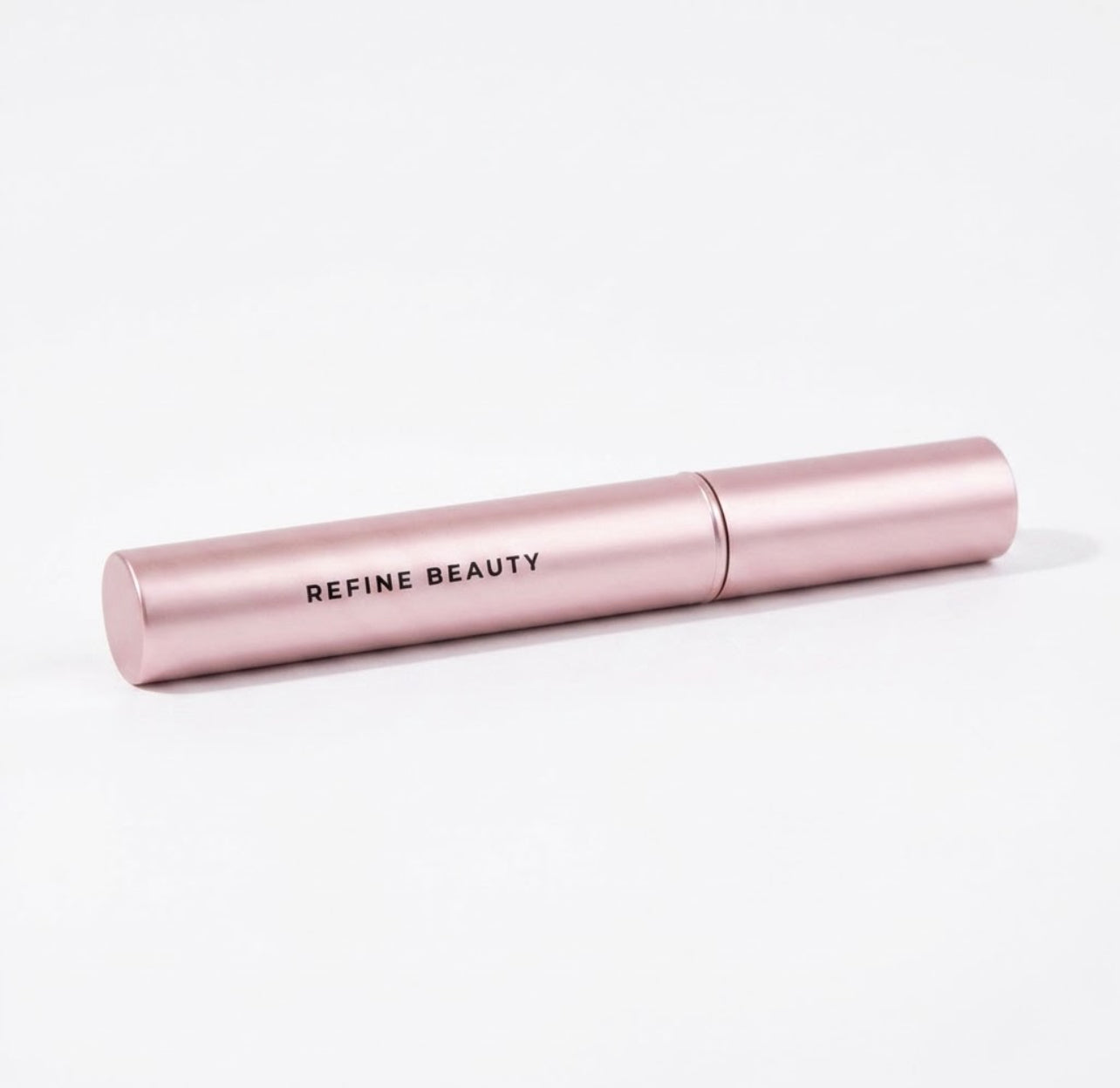 Refine Beauty Volume mascara on a light gray background