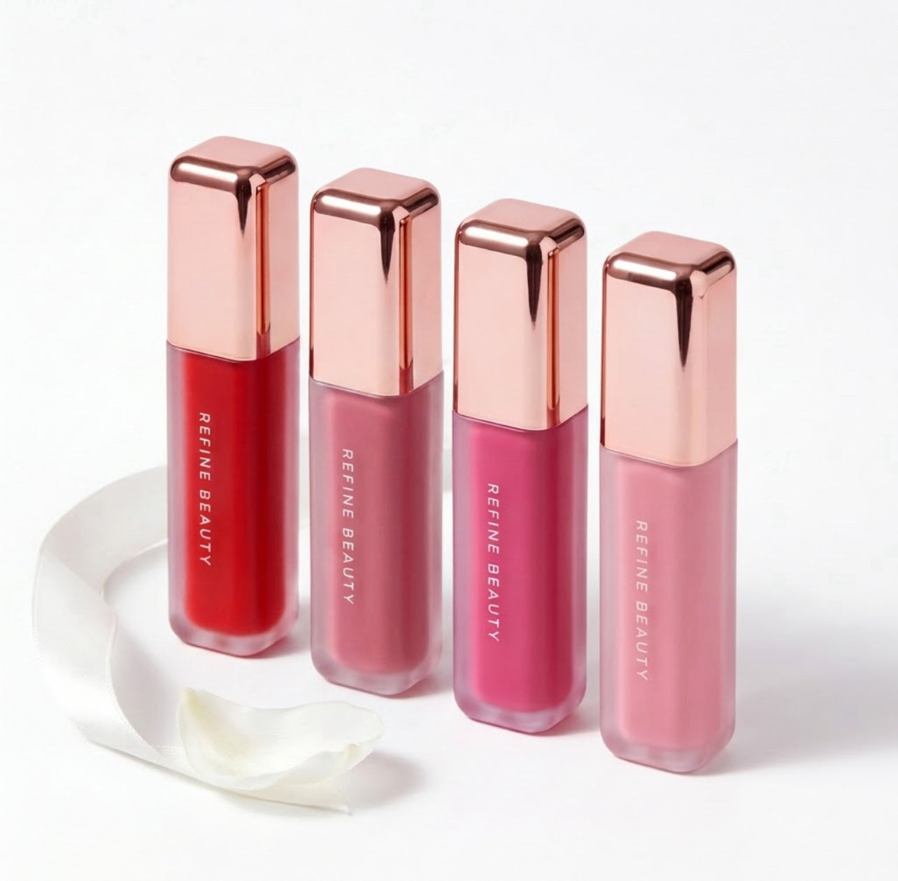 Refine Beauty blush with rose gold caps on a white background