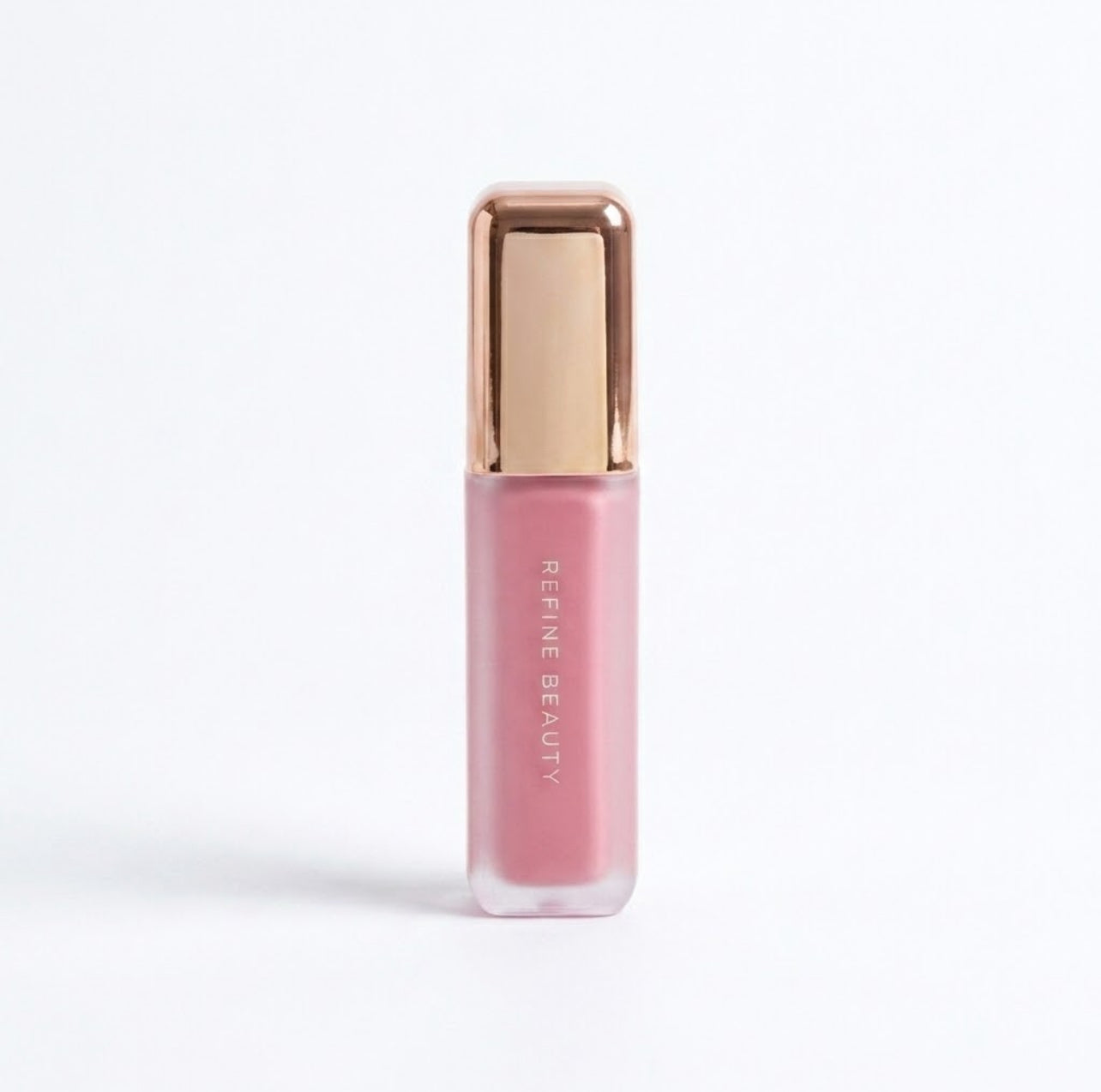 Refine Beauty blush with rose gold cap on a white background