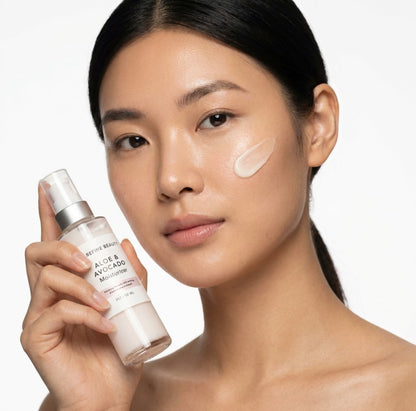 Woman holding Refine Beauty  Aloe & Avocado moisturizer skincare product with a white background