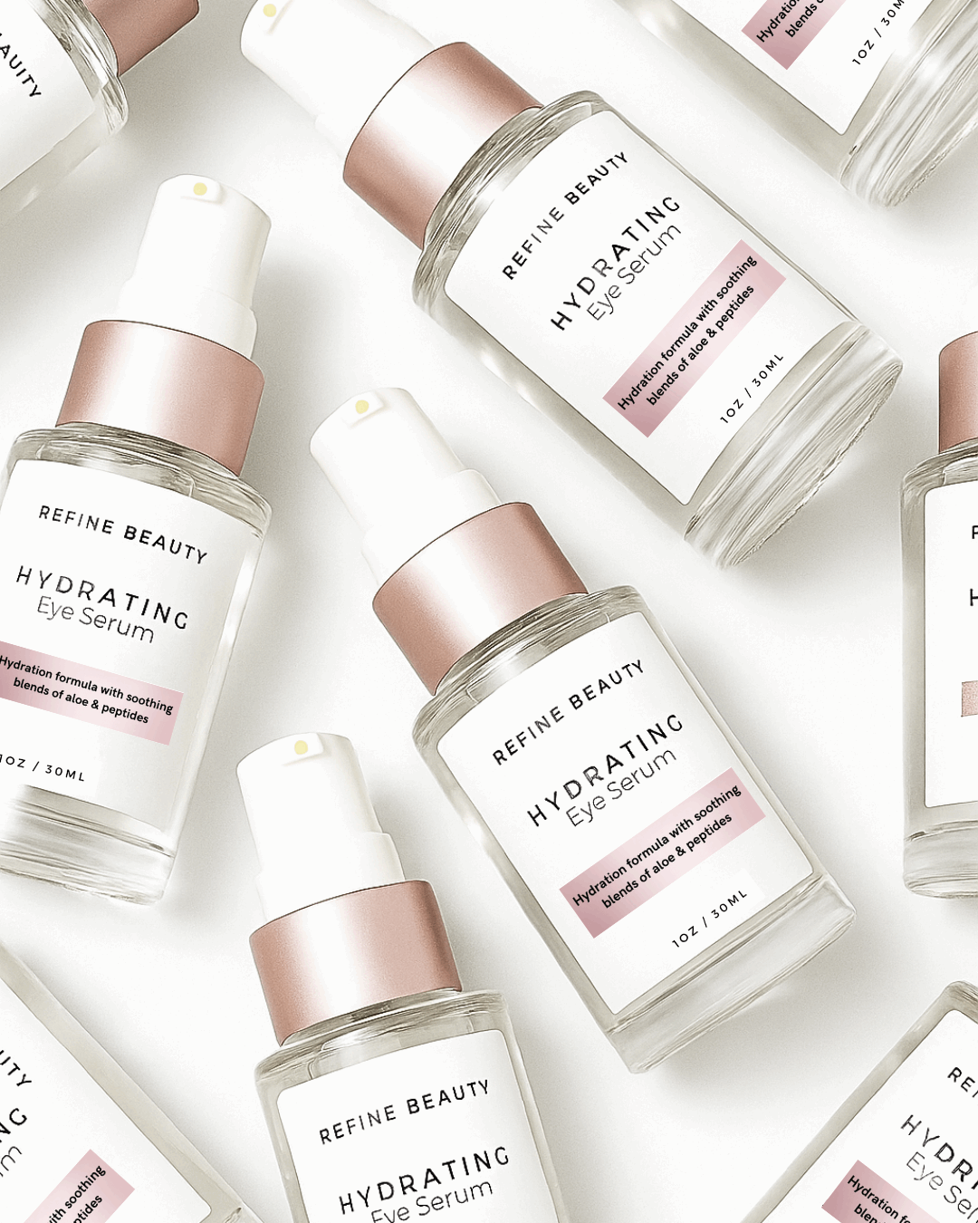 Multiple bottles of Refine Beauty Hydrating Eye Serum on a light background